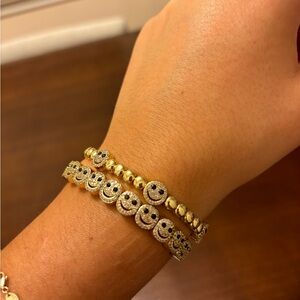 Set two Lisa Gozlan smiley gold bracelets